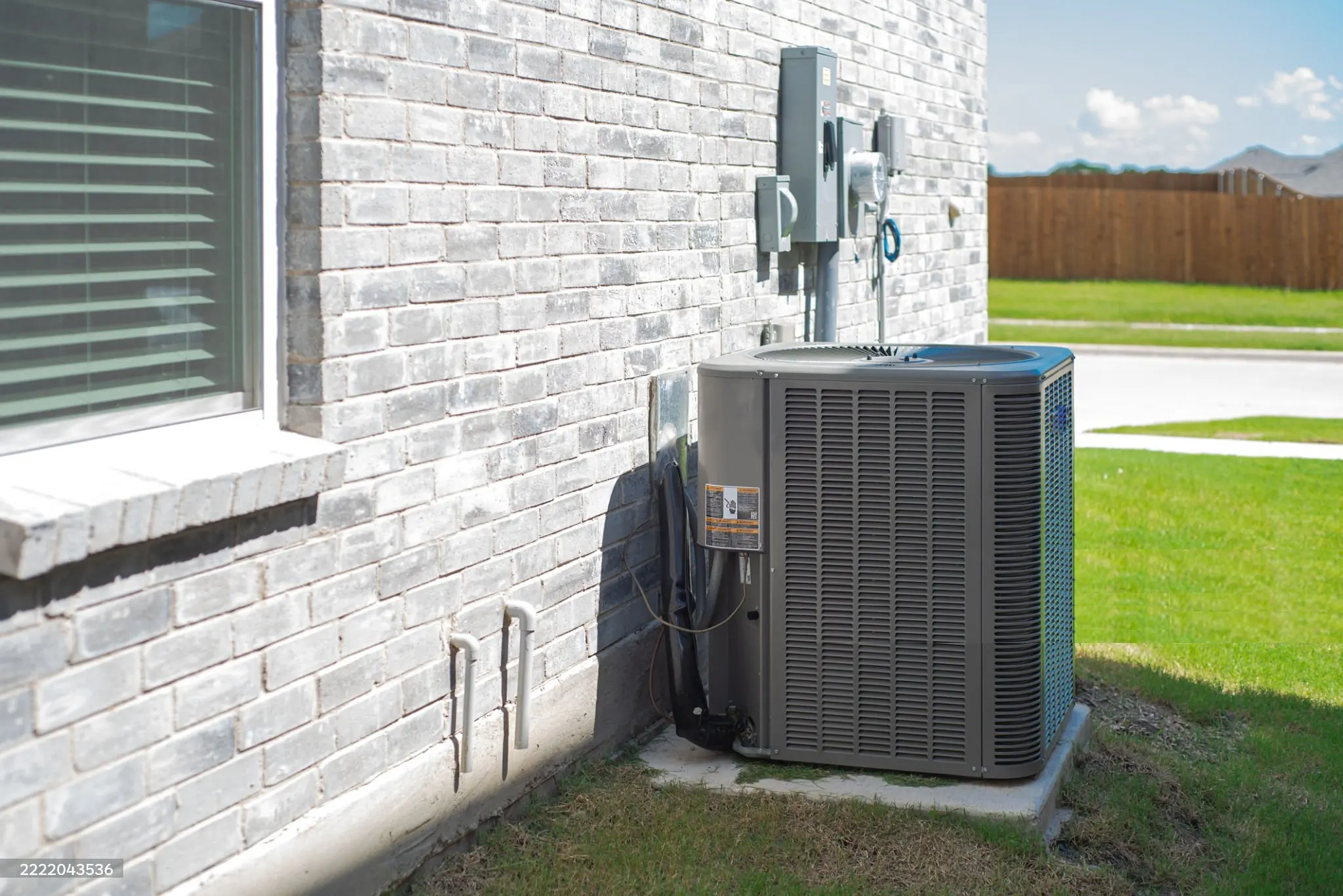 AC hero image 4 Outdoor air conditioner condenser unit beside a home